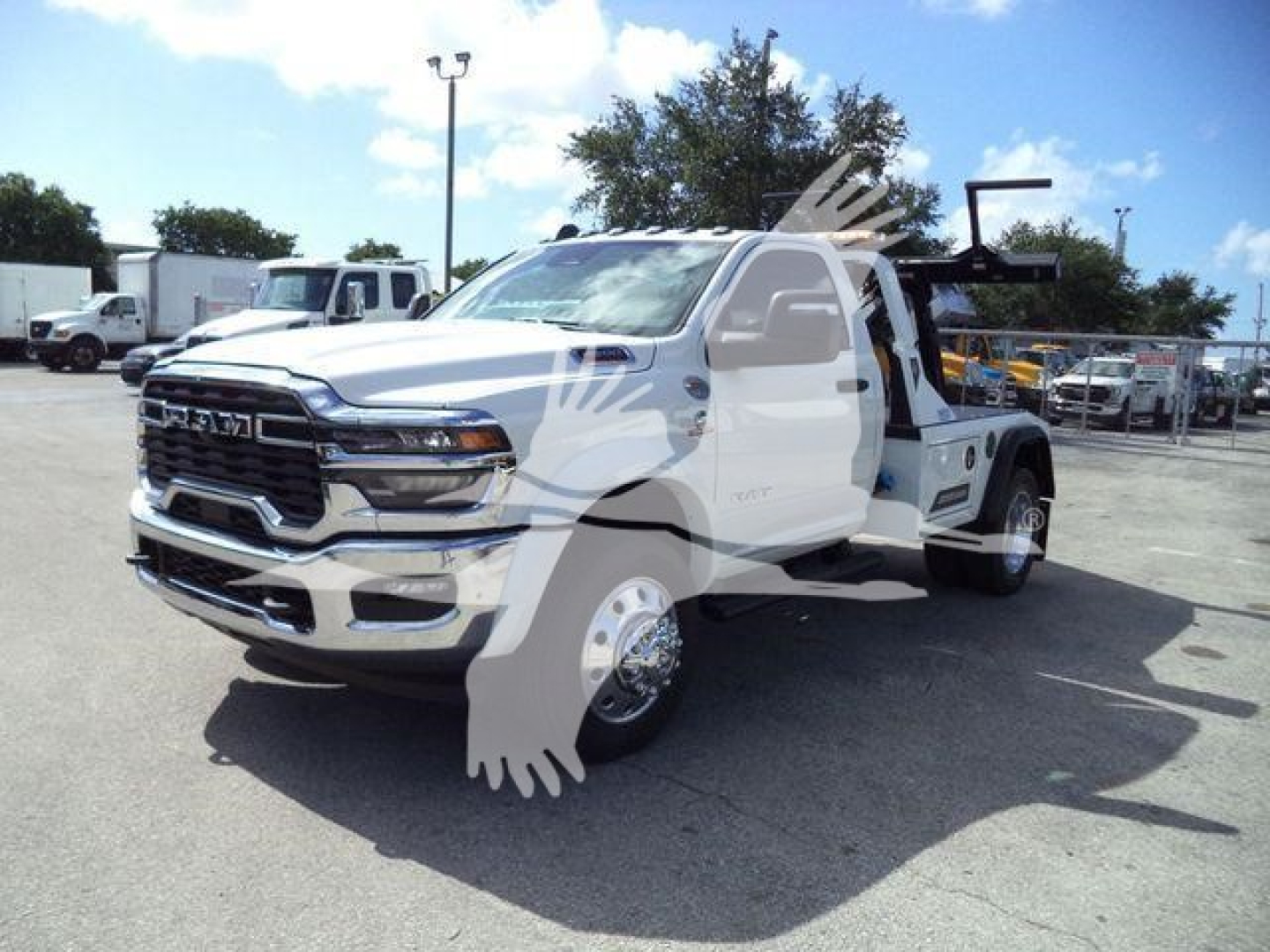 Ram 4500 tow truck cab in front with chrome grille and winch equipment, side view showing dual rear wheels and tow bed.
