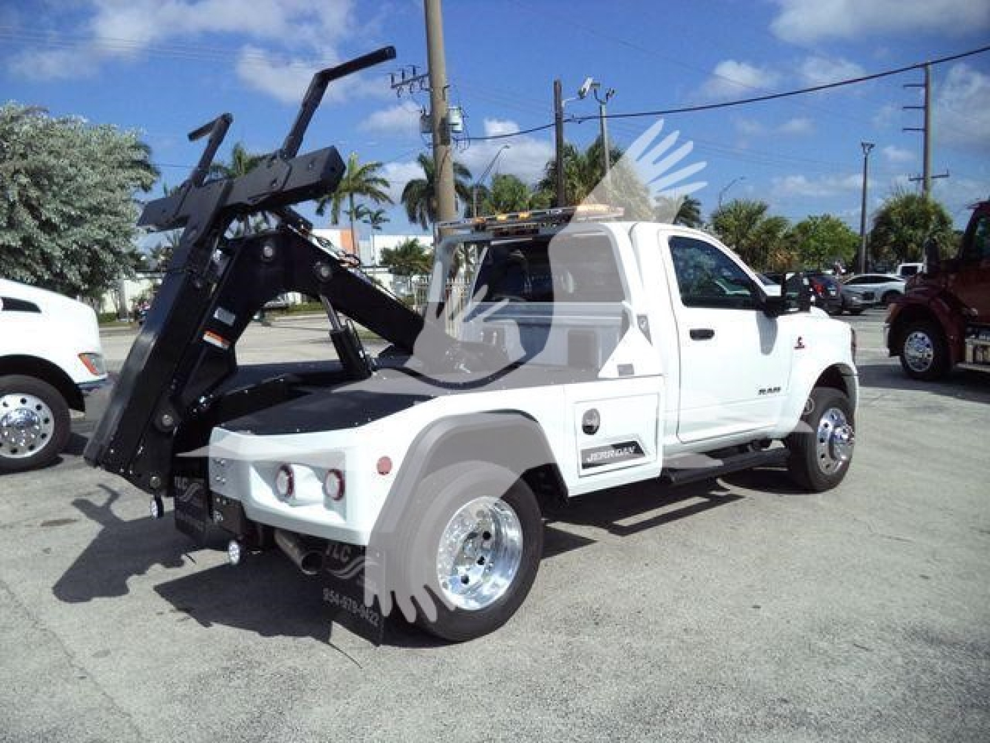 Tow-ready Ram 4500 truck with a large hydraulic winch/boom mounted in the bed, white cab, side view, stock number J17748, VIN 3C7WRKAL0TG217748