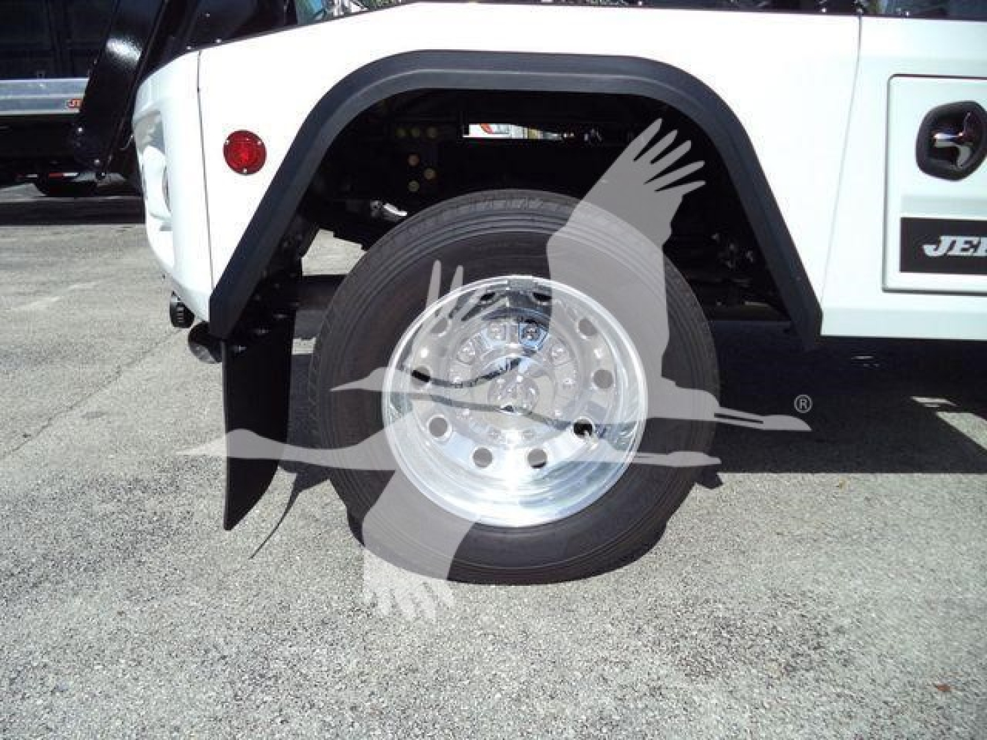 Ram 4500 wheel and fender view showing front wheel and part of white body with JEEP-like logo on door.