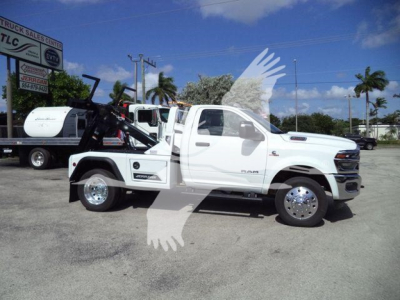 Ram 4500 truck in a dealership lot with winch and crane equipment mounted on the bed, white exterior, stock #J17748.