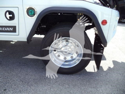 Truck wheel well and front tire of a Ram 4500, with a chrome wheel, blue body, and black fender flare visible.
