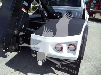 Ram 4500 winch-equipped truck bed with rear bumper and tow hitch, dual red taillights, and equipment decals visible.