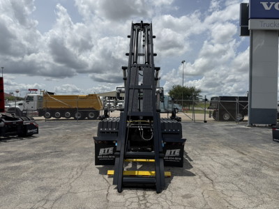 Front view of 2026 Mack GR64B roll-off truck chassis with fork attachments and hydraulic arms, VIN 1M2GR2GC9TM054664, stock 70393.