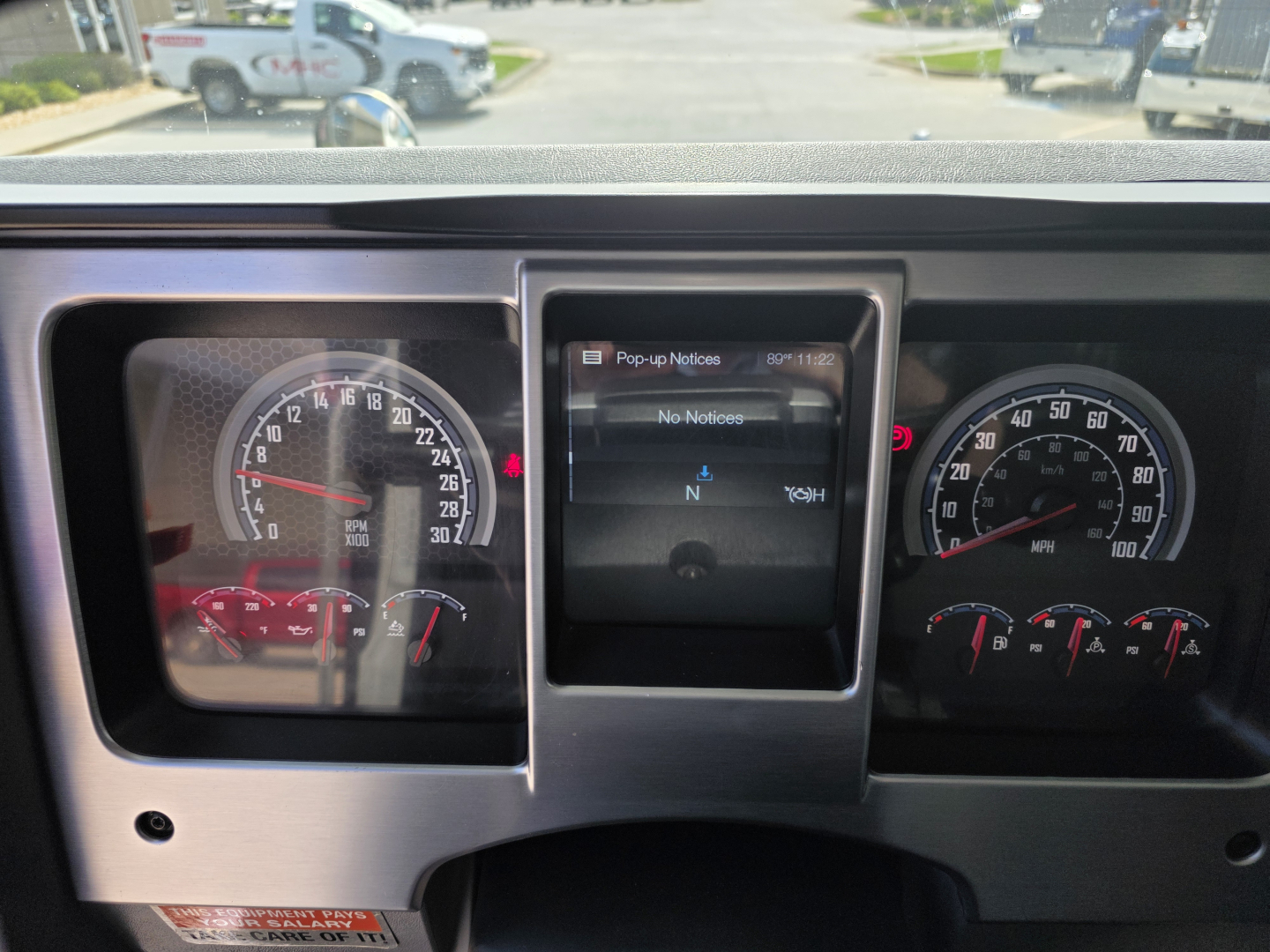 Dashboard of a 2022 Mack GRANITE dump truck showing speedometer and tachometer with central multi-function display.