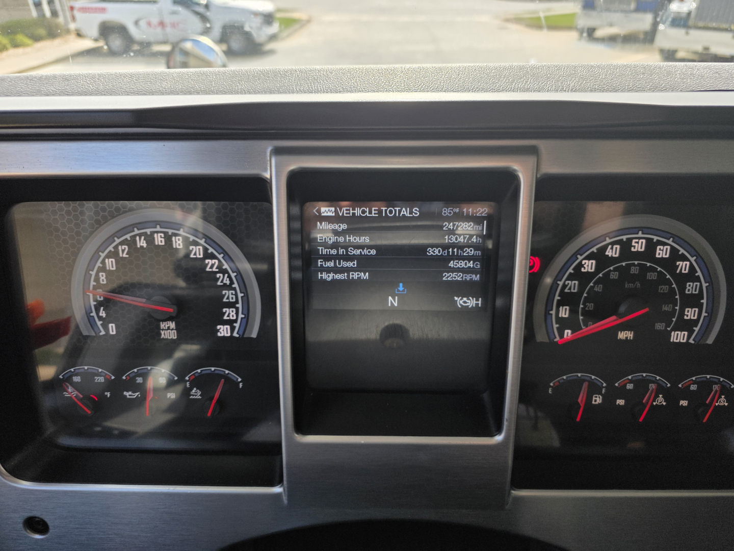 Mack Granite dashboard view showing instrument cluster and central display with vehicle totals such as mileage, engine hours, fuel used, and highest RPM.
