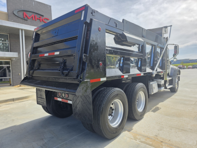 Dump truck rear and side view showing heavy-duty dual rear axles and Mack GRANITE dump bed