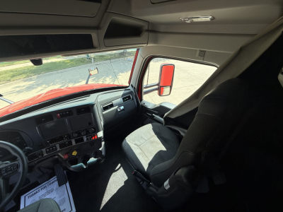Kenworth T680 truck cab interior showing dashboard and driver seat with steering wheel and controls.
