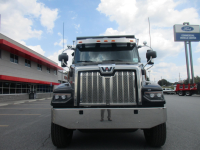Western Star heavy-duty dump truck front view showing chrome grille and bumper in dealership lot.