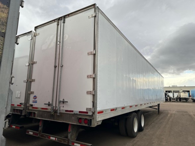 Trailer showing utility van trailer with rear double doors and dual rear axles.