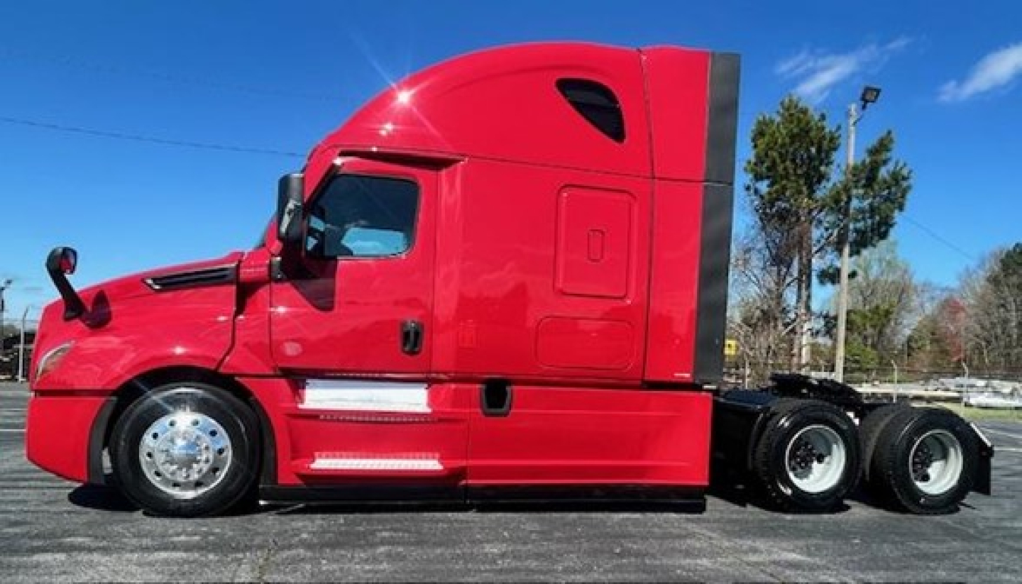 Freightliner Cascadia 126 sleeper cab in red, side profile showing cab and axle configuration.