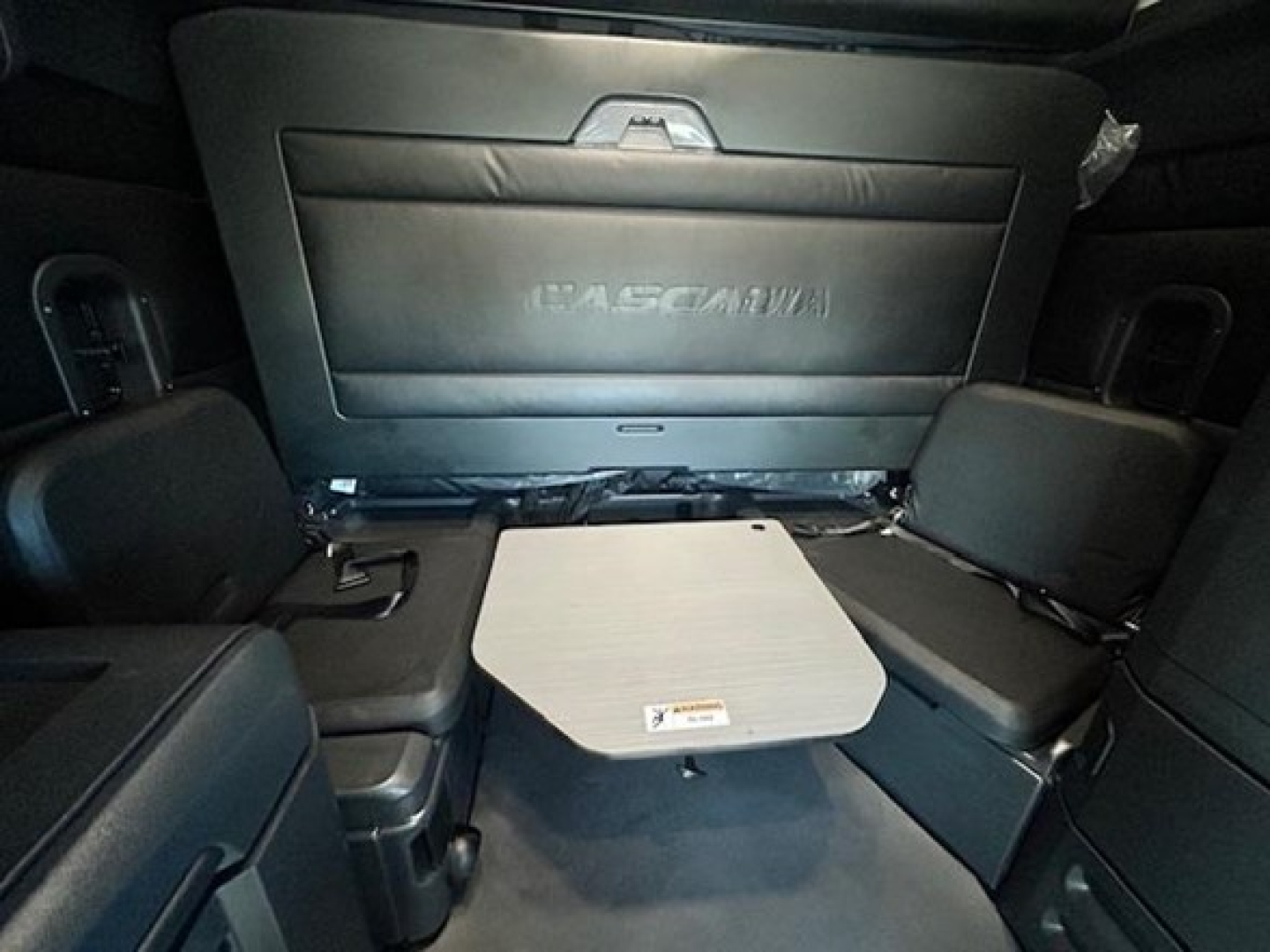 Freightliner Cascadia 126 sleeper cab interior showing rear seat area with fold-out table and seat backs.