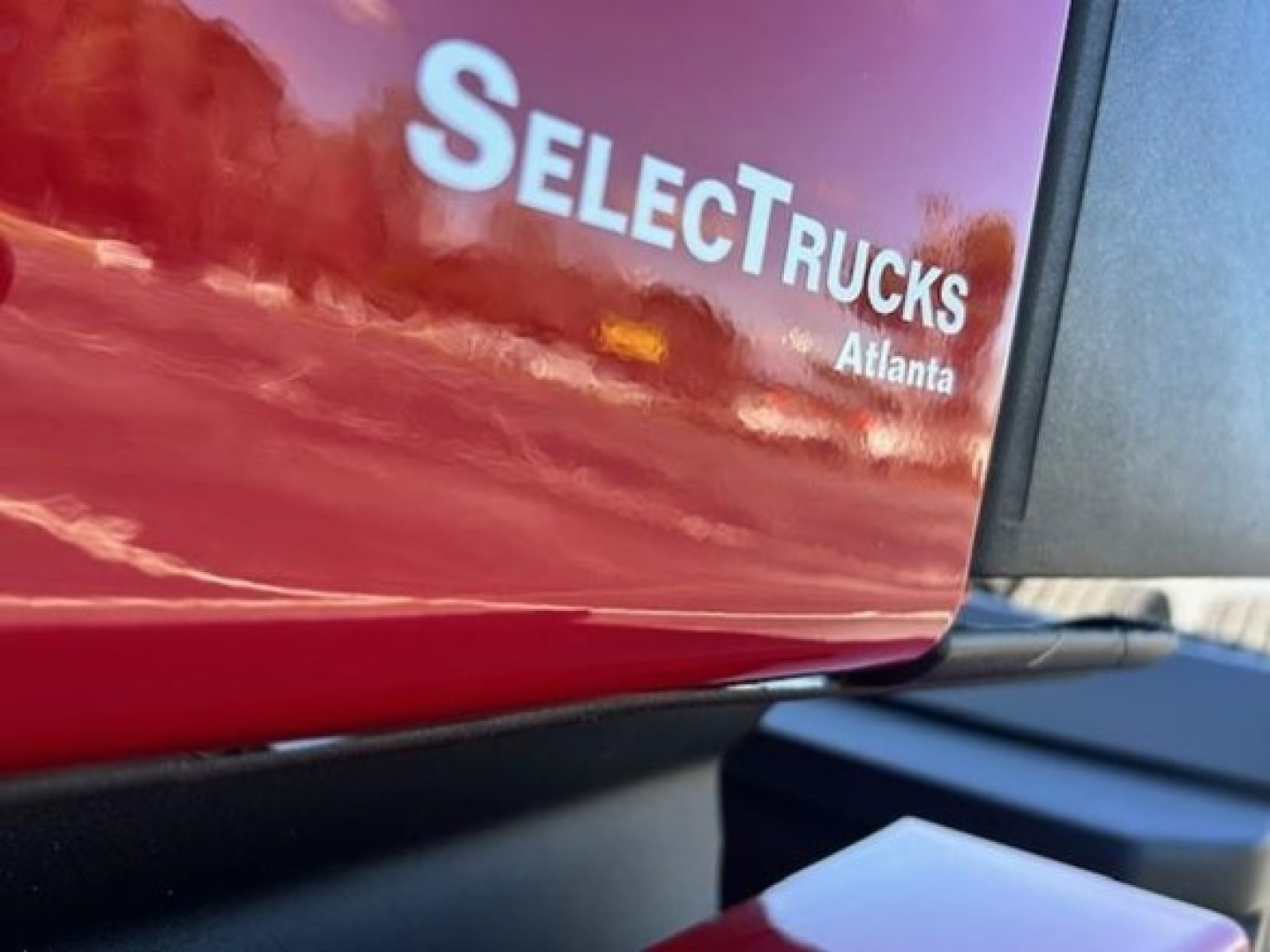 SelectTrucks Atlanta logo on a red Freightliner Cascadia 126 cab with partial VIN 3AKJHHDR4PSUB1133 visible.