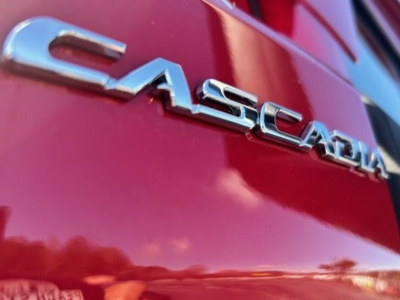 Freightliner Cascadia badge on a red truck rear