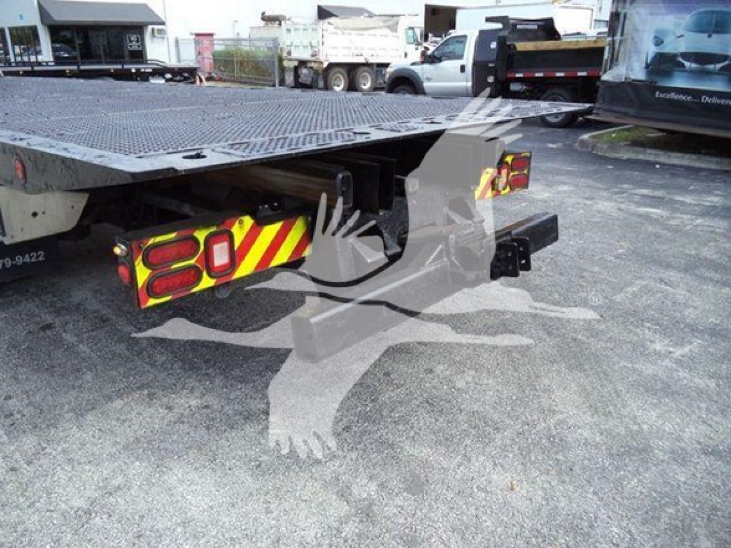 Truck chassis rear with a flatbed platform and reflective rear lights, Peterbilt 367 rollback setup.