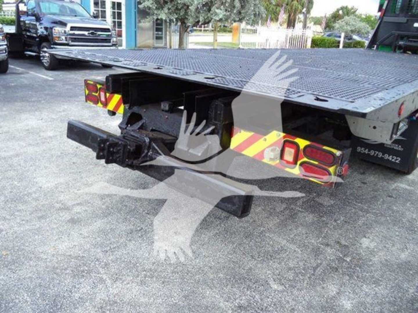 2014 Peterbilt 367 rollback truck rear view showing flatbed, rear hitch, and reflective safety chevrons with stock number T26743 and VIN 1NPTL40XXED226743.