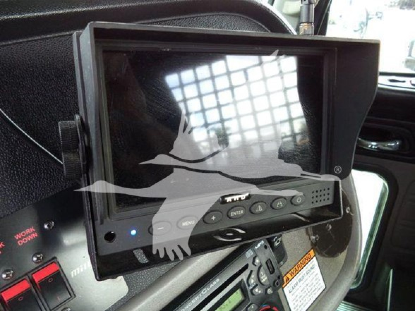 In-cab monitor display mounted in Peterbilt 367 showing touchscreen controls and dashboard nearby.