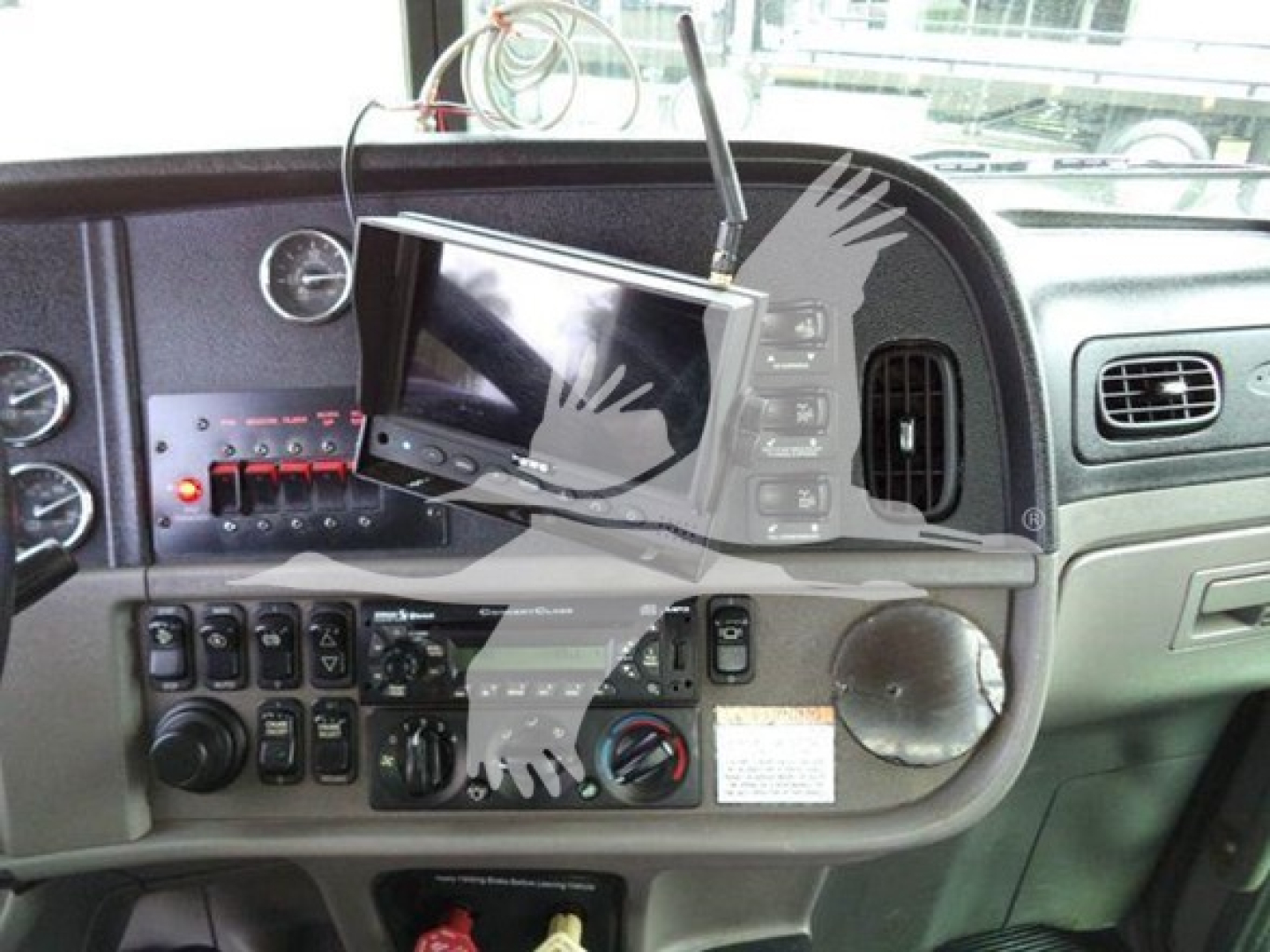 Peterbilt 367 truck cockpit with dashboard controls and a fold-out monitor on the center console, VIN 1NPTL40XXED226743, rollback equipment visible.