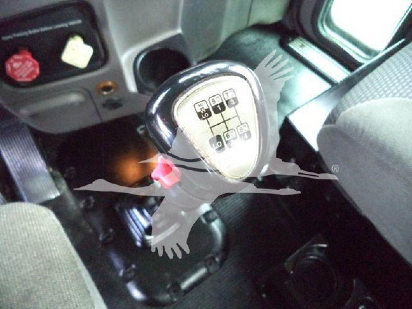 Peterbilt 367 interior with manual shifter knob showing gear positions. Dashboard and steering area visible.