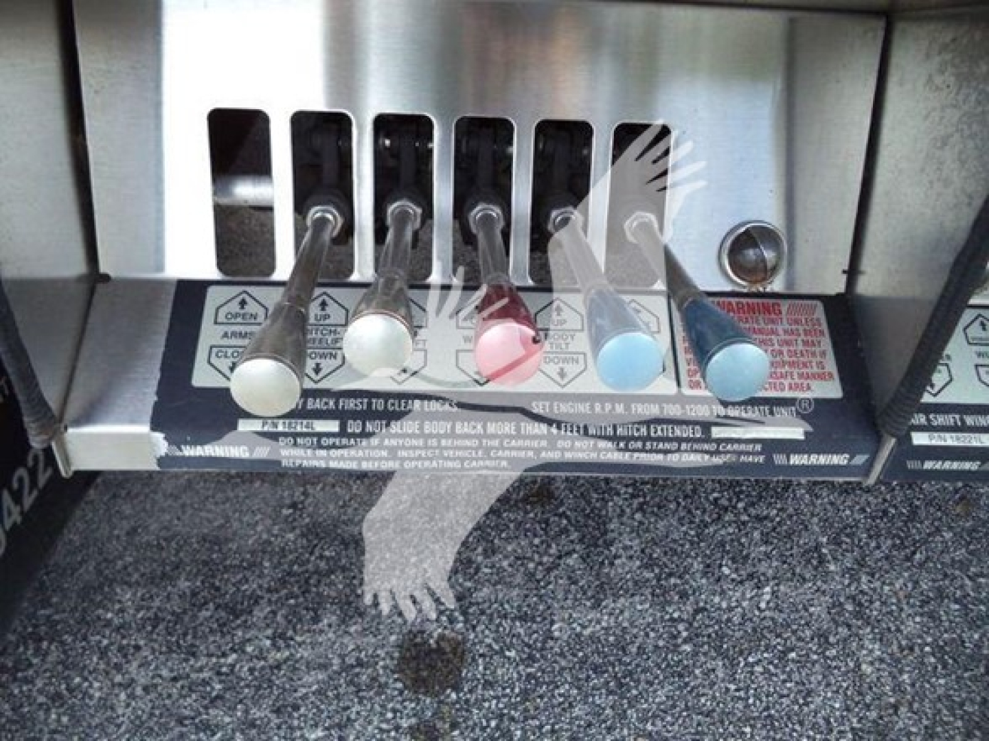 Peterbilt 367 rollback control panel with multiple color lever handles and warning decals visible.