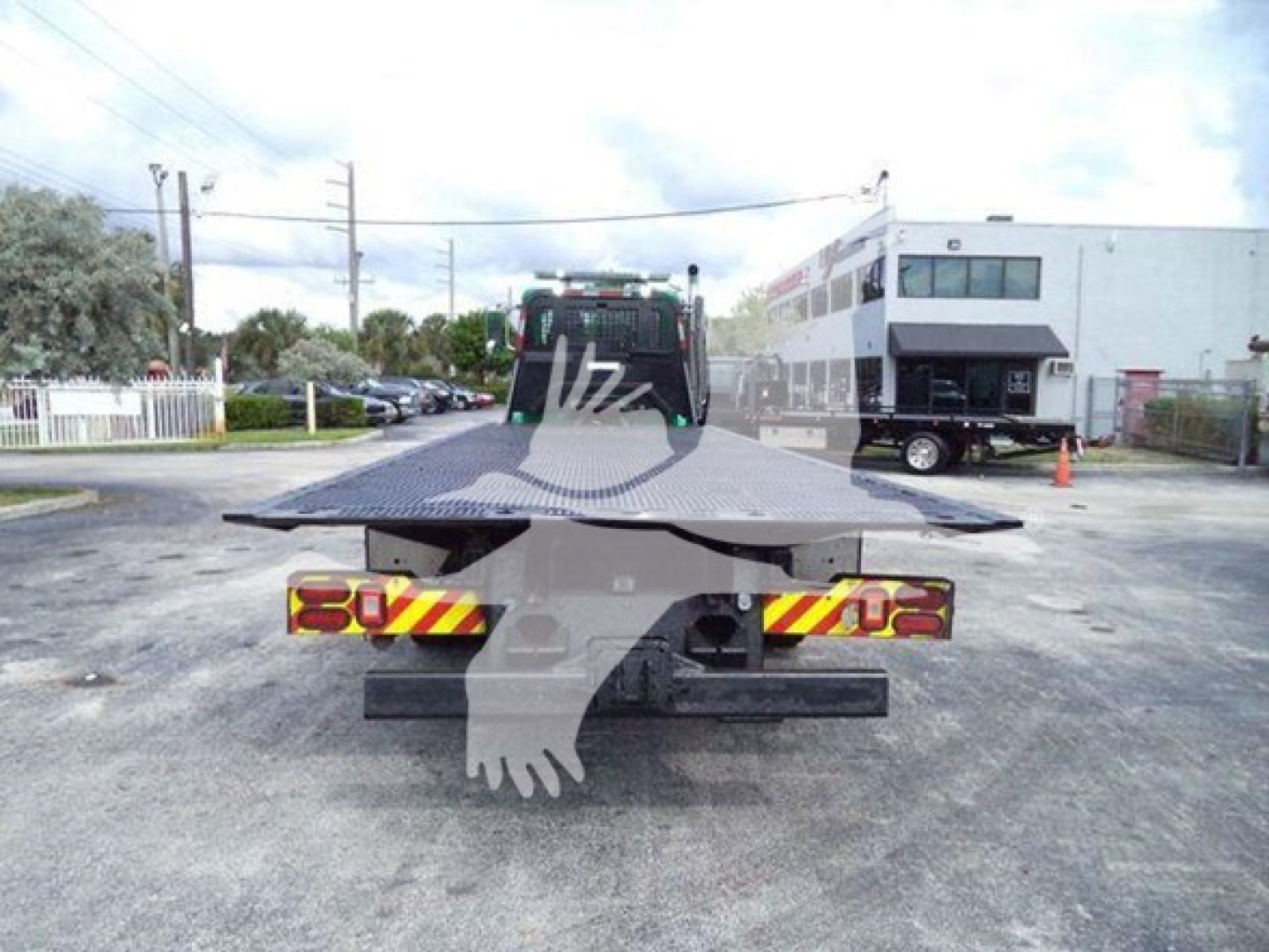 Peterbilt 367 rollback truck with flatbed viewed from rear; license-plate area obscured by watermark.
