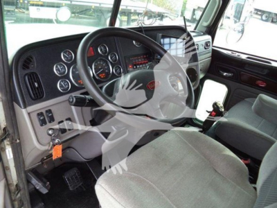 Peterbilt cab interior showing steering wheel and dashboard with gauges in a 2014 Peterbilt 367 rollback truck.