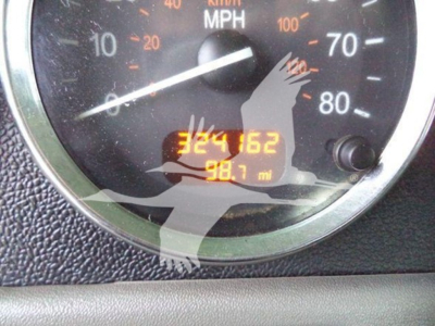 Dashboard gauge cluster showing speedometer with numbers and an odometer reading 324162 miles and 98.7 miles.