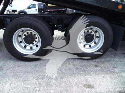 Truck wheel set and fender area showing dual rear tires and Goodyear tires on a Peterbilt 367 rollback chassis.