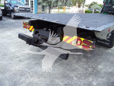 2014 Peterbilt 367 rollback truck rear view showing flatbed, rear hitch, and reflective safety chevrons with stock number T26743 and VIN 1NPTL40XXED226743.