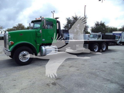 Peterbilt 367 rollback truck in green, side view with extended flatbed and towing equipment, used vehicle.