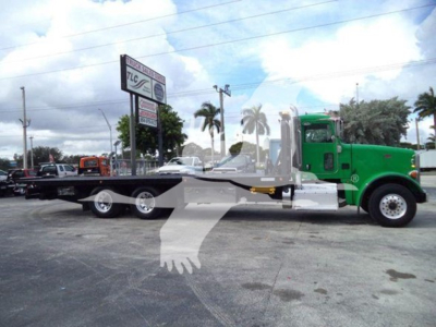 Peterbilt 367 rollback tow truck with long flatbed and green cab, side view, VIN 1NPTL40XXED226743.