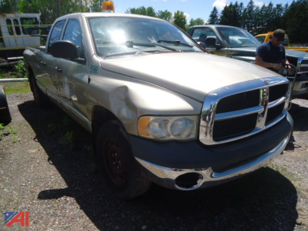 Dodge Ram 1500 pickup truck (2004) in-use condition shown from front-left view with dented front fender and chrome grille.