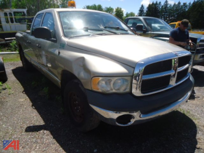 Dodge Ram 1500 pickup truck (2004) in-use condition shown from front-left view with dented front fender and chrome grille.