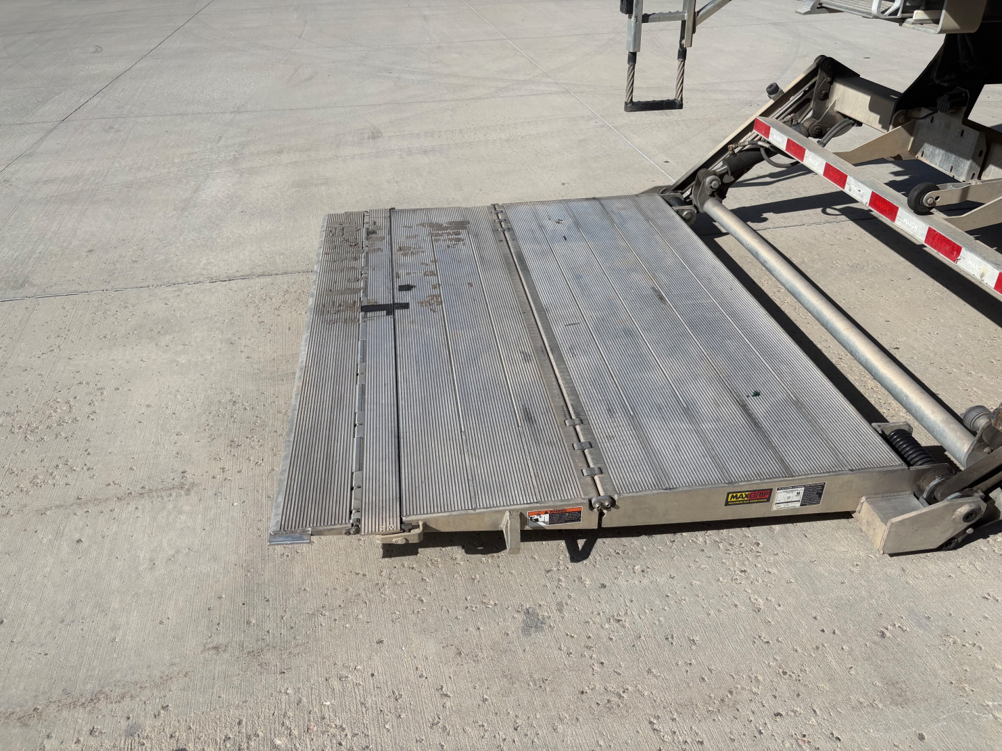Freightliner M2-106 mobile ramp platform with aluminum surface and hydraulic lift, view of rear deck and ramp edge.