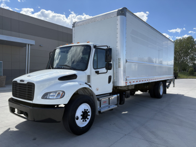 2022 Freightliner M2-106 box truck with white cab and cargo box, side view showing front grille, dual rear wheels, and reflective side trim.
