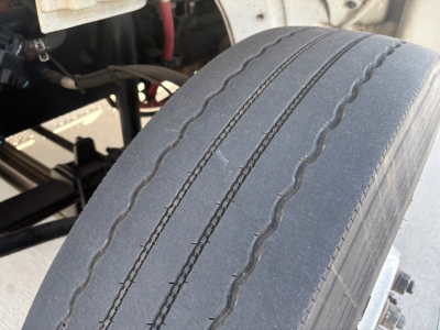Wheel/view of 2022 Freightliner M2-106 chassis showing tire tread and undercarriage components.