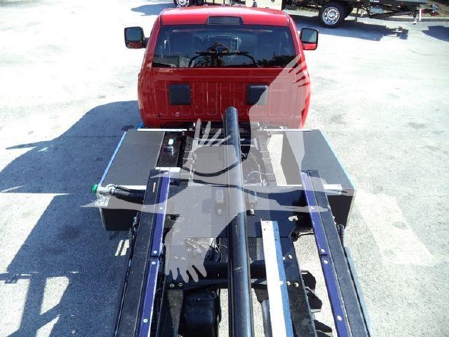 Ram 5500 rollback bed setup showing chassis attachment and hydraulic components from rear view