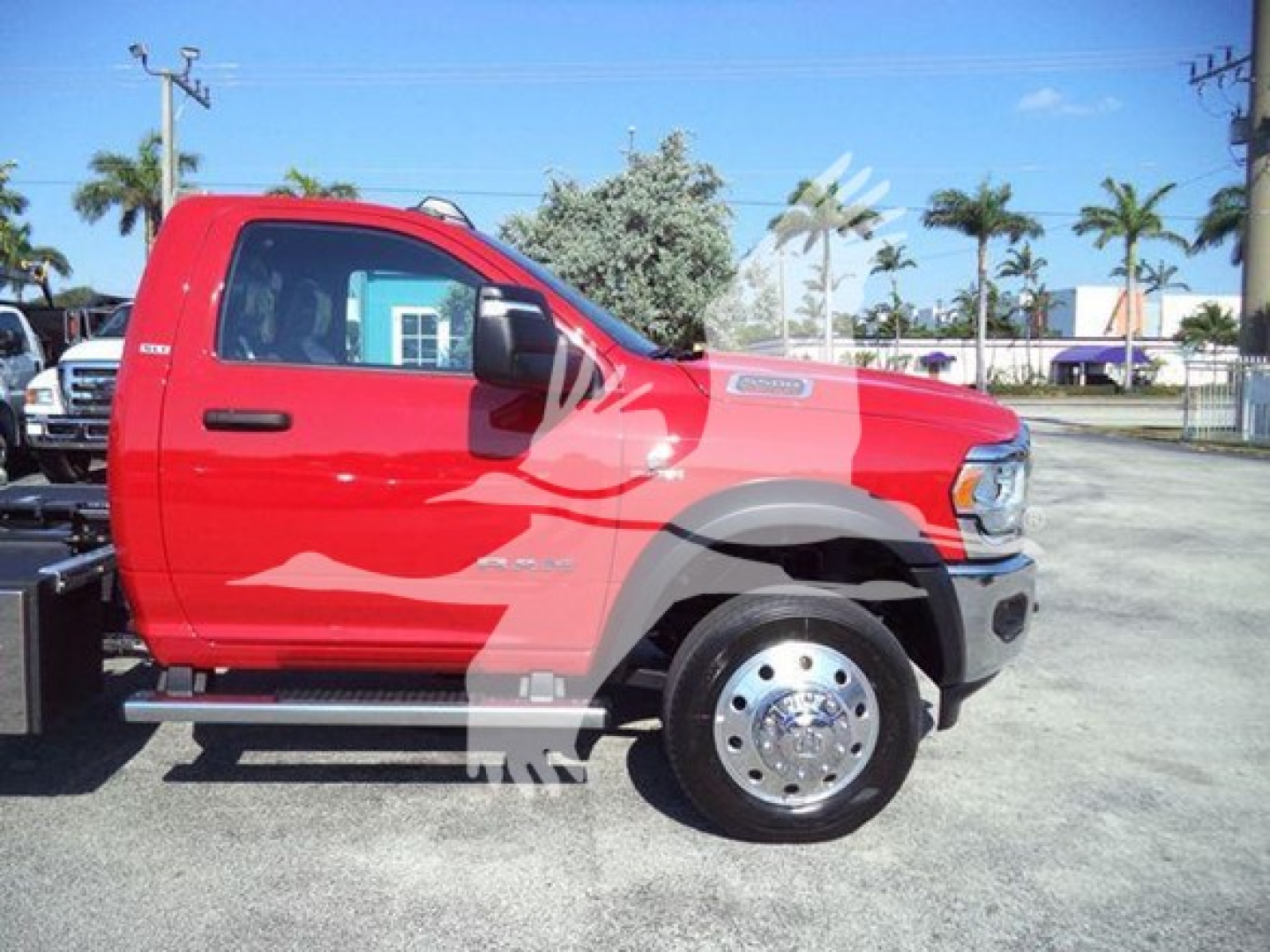 Ram 5500 SLT truck in red side profile showing extended cab, chrome front wheel, side step, and rollback equipment mounting.