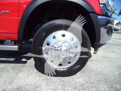 Ram 5500 front wheel and fender view showing steel wheel with hubcap, tire, and part of red body panel; no visible text readable.