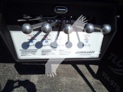 Ram 5500 rollback unit control panel with five spherical levers and labeled instructions.