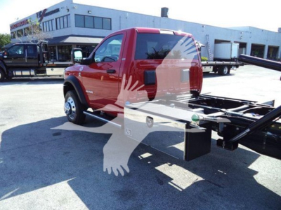 Ram 5500 rollback chassis shown from side rear with red cab and flatbed framework.