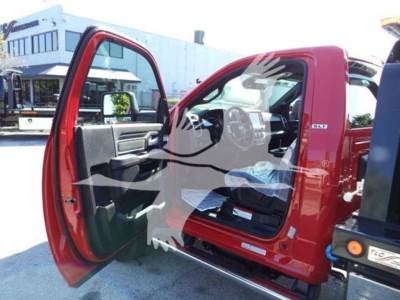 2024 Ram 5500 SLT truck rollback service body with driver-side door open showing interior dashboard and seating.