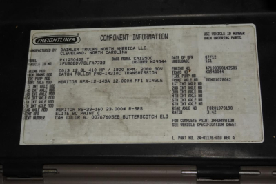 Freightliner component information placard in engine bay showing model CASCADIA 125 information including VIN, stock, and engine/transmission details.