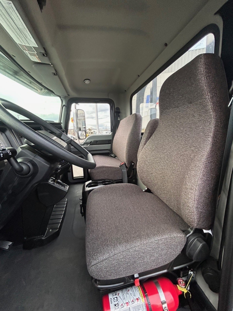 Mack MD6 cab interior showing driver and passenger seats and dashboard.