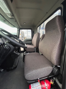 Mack MD6 cab interior showing driver and passenger seats and dashboard.