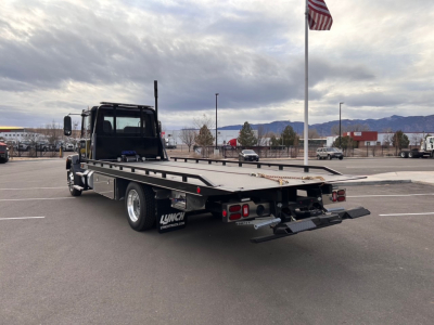 Flatbed tow truck rear and side view showing bumper and taillights