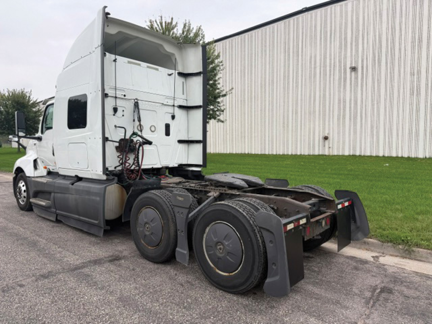 International LT625 tractor with sleeper cab, side view showing rear wheels and fifth-wheel area