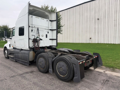 International LT625 tractor with sleeper cab, side view showing rear wheels and fifth-wheel area