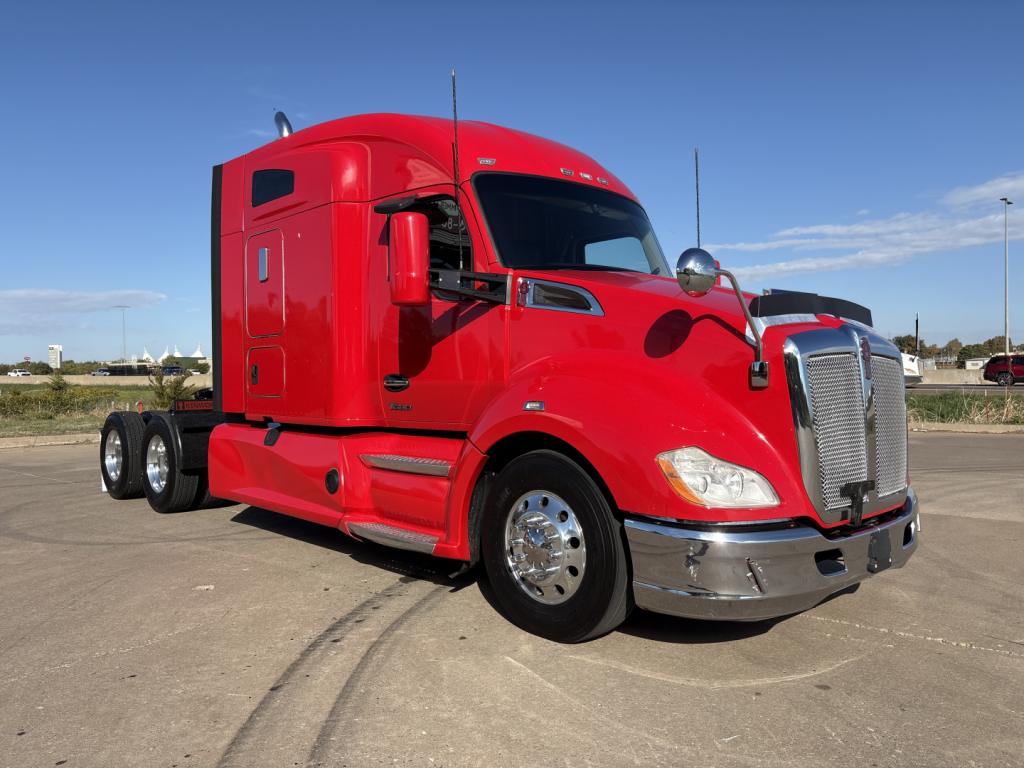 Kenworth T680 truck in red cab shows front grille, aerodynamic mirrors, side exhaust, sleeper cab, dual rear axles, chrome bumper and wheels.