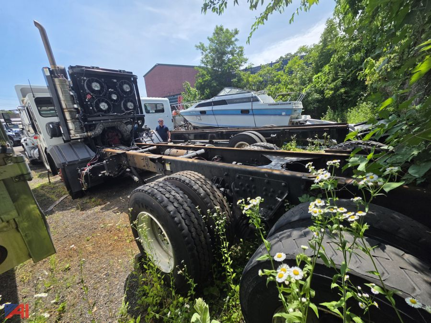 Cab and chassis truck frame with large dual rear wheels and crane control panel visible in rear, Toyota crane carrier LET2-46 identifying components