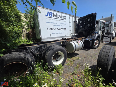 Truck chassis with crane carrier LET2-46 cab and chassis showing JB Moving trailer and exposed frame components.